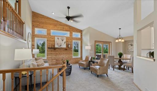 Living room with wood paneling and views to the backyard