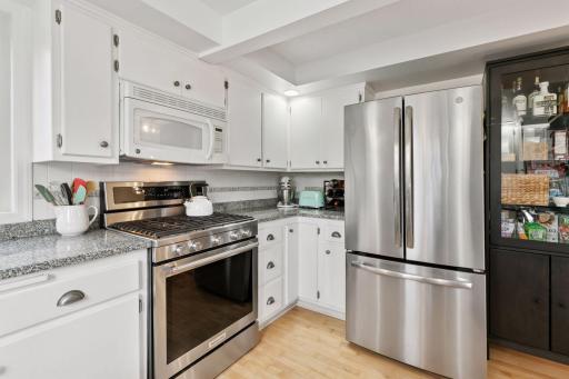 Hardwood floors, recessed lights, 2 new Andersen windows and a large sink with window.