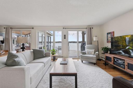 Large open living room with sliders to the deck and porch. New white oak hardwood floors 2024.