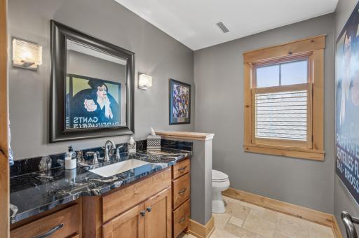 Details and storage continue - including the in the additional bathroom; with tile floors and undermount sink in a beautiful stone-top vanity