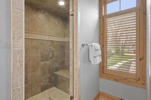 Large walk-in, tiled shower with glass enclusure