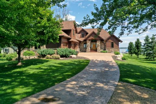 Custom stamped concrete driveway blends perfectly with the landscaping