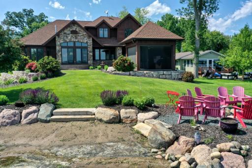 Custom stone walkway leading to the sandy beach surrounded by riprap