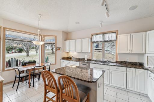 So much to love about this updated kitchen! Light, bright, loads of cabinets and counter space, center island and a sunny spot for breakfast.