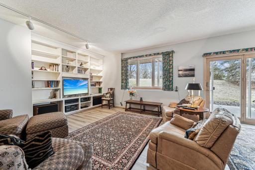 Lower level walk-out with large window and built-in book cases.