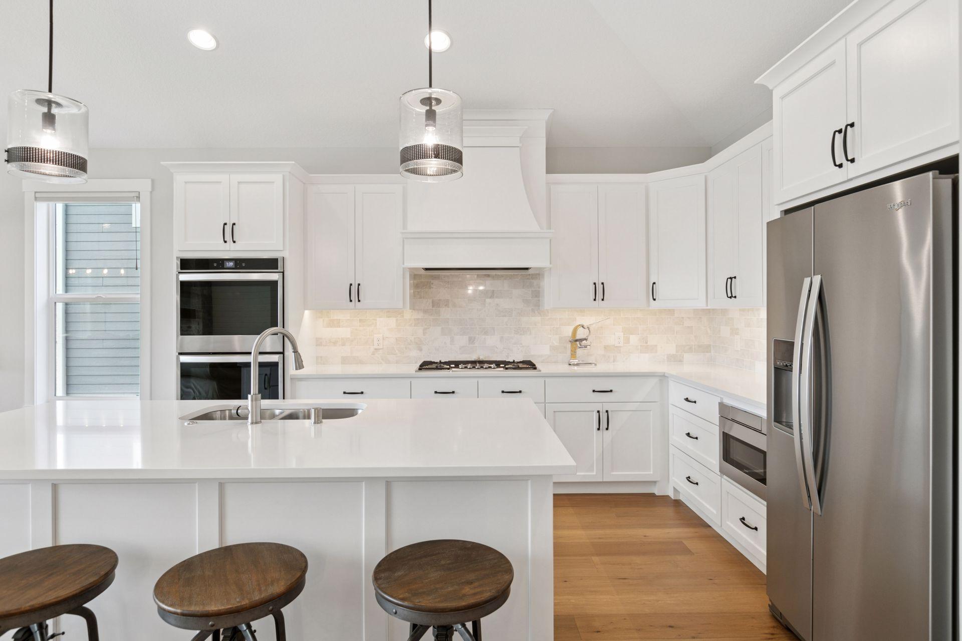 High-end appliances and luxe finishes elevate the heart of this open-concept kitchen.