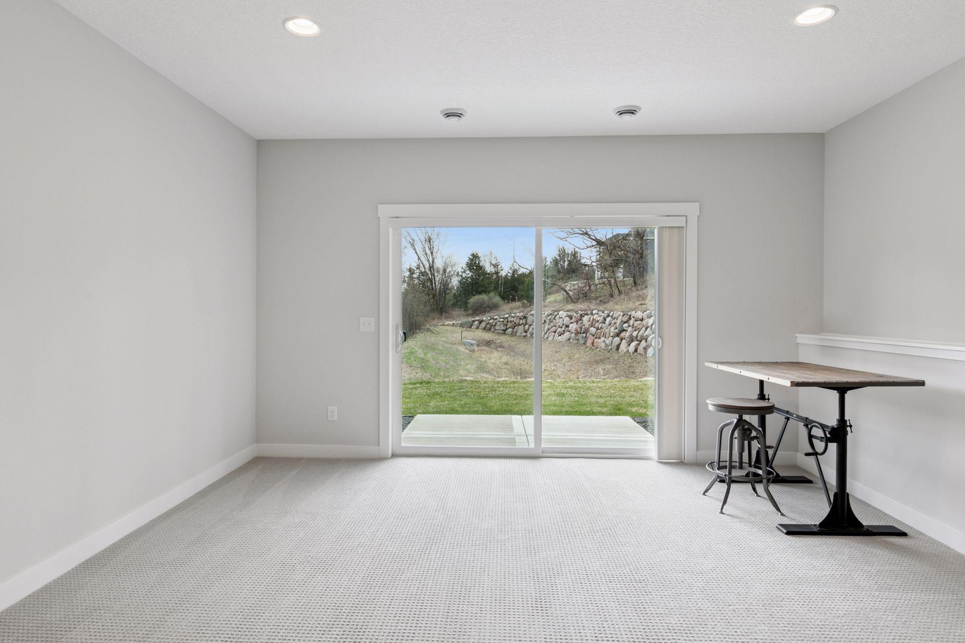 Bright and clean lower-level family room with convenient walk-out access.