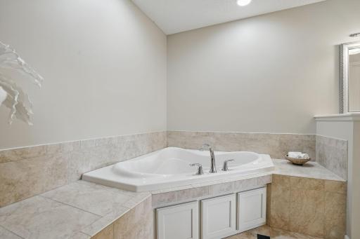 The ownerâs suite includes a relaxing corner soaking tubâperfect for unwinding at the end of the day, with tile surround.