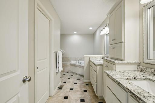 The ownerâs bath includes a corner soaking tub, a separate updated shower (2023), and direct access to a walk-in closetâoffering both luxury and convenience.