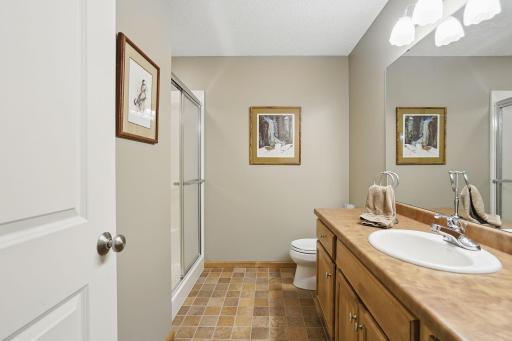 The lower-level Â¾ bath features tile flooring, a large vanity, and a spacious layoutâconveniently located near both lower bedrooms and the family room.