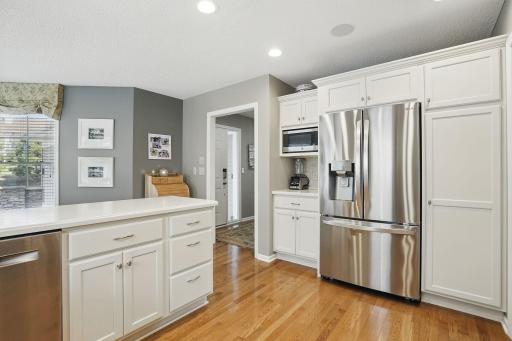 From the entryway, youâre greeted with a view of this beautifully updated kitchenâshowcasing recessed lighting, white cabinets, and thoughtful design.
