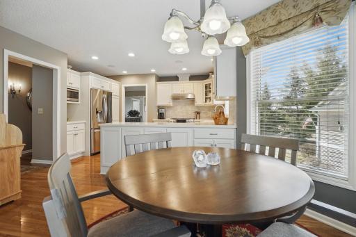 Open layout flows into the kitchen, highlighted by recessed lighting and clean white cabinetryâcreating a bright and functional cooking space.