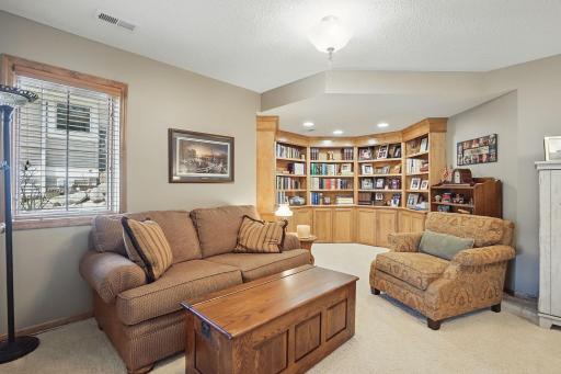 Originally designed as an office, this spacious lower-level room features built-in bookshelves, making it a perfect space for working from home, reading, or hosting overnight guests.