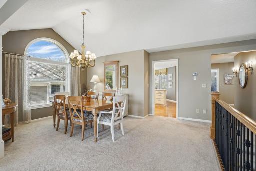 This open layout offers a spacious flow from the living room to the vaulted dining roomâan ideal setup for entertaining family and friends with plenty of room to gather.