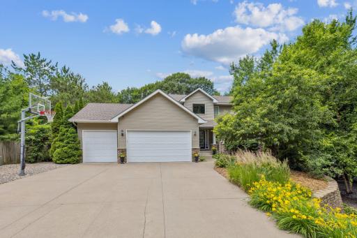 Spacious driveway, manicured garden beds, and inviting entry welcome you home to this private setting.