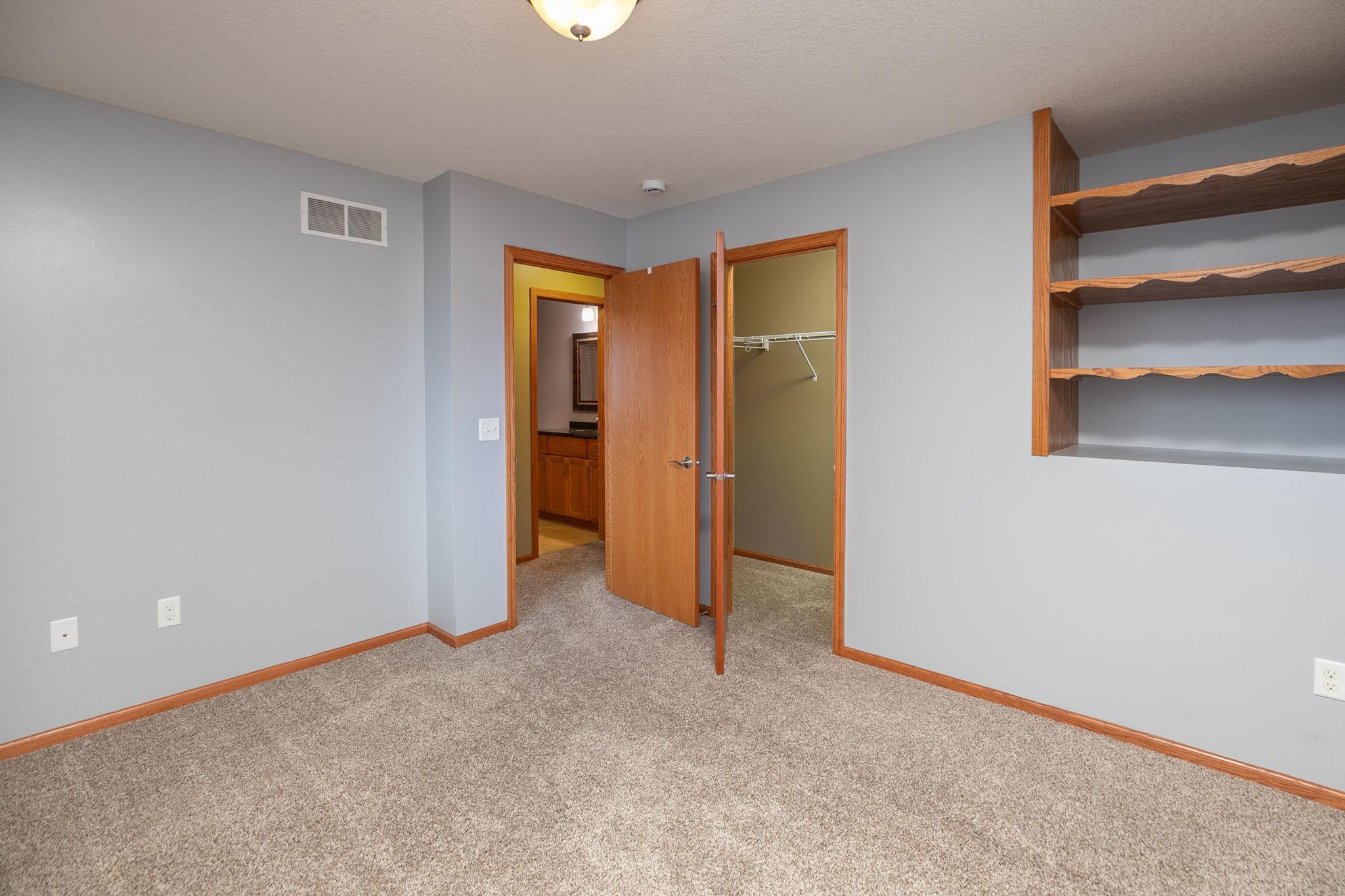 Bedroom 1, main floor w/walk-in closet & built-in shelf