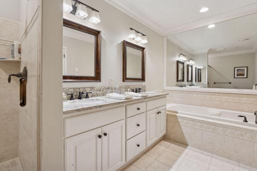 Features double vanities, plenty of cabinet space, and separate tub