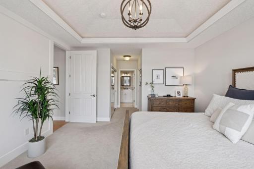 The primary bathroom ensuite includes dual sinks, a separate shower, and a luxurious soaking tub