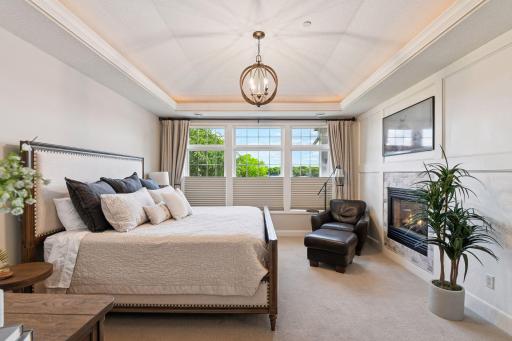 The primary suite offers spectacular views of Lake Minnetonka, a cozy fireplace, and a full ensuite bathroom