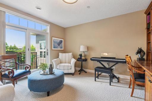 The den offers direct access to a private balcony