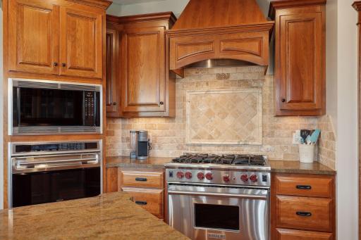 Enjoy cooking with a professional appliance package from Wolf including a 6-burner gas range, separate wall oven, built-in microwave, SubZero refrigerator, and Bosch dishwasher.