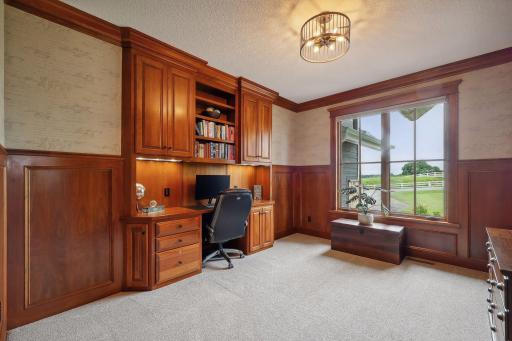 A truly Executive Home Office, this well-appointed workspace features designer wall coverings and a built-in desk.