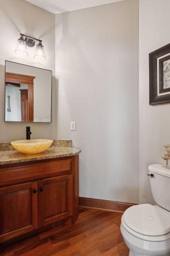 The Powder Room offers a furniture-style vanity topped with granite and designer fixtures.