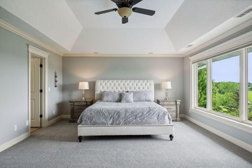 Your private oasis - the Primary Bedroom features enameled millwork and a tray vault ceiling.