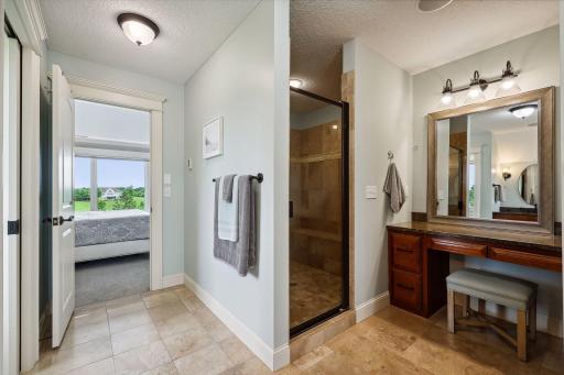 The large shower offers two shower heads and a built-in bench.