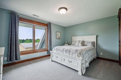 In addition to the Primary Suite, the upper level houses two Junior Bedrooms - each bedroom features a large walk-in closet.
