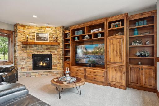 Perfect for movie night, the lower level family room offers a wall-to-wall built-in entertainment center and gas fireplace.