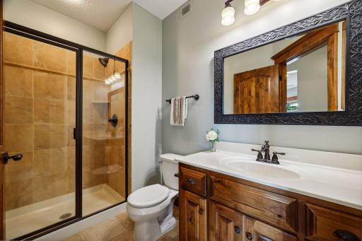 The lower level offers a 3/4 Bathroom with a tiled shower and glass enclosure.