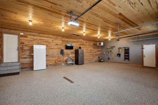 Fully finished, the oversized garage is heated and offers polyaspartic flooring, in-floor drains and new wood paneled ceiling.