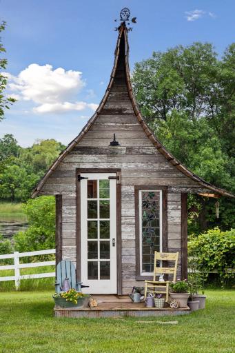 A She-shed sits on the property and offers a whimsical space for potting plants and storing your gardening toys.
