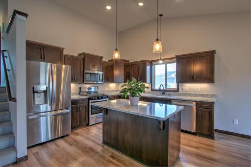 Stunning kitchen equipped with Stainless Steel appliances, under cabinet lighting and a center island