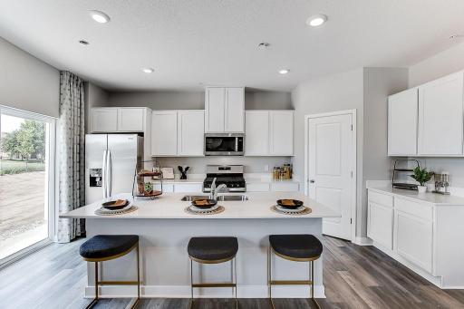 Townhome living just got an upgrade with the large island, spacious walk-in pantry and tons of cabinets. *Model home- colors and finishes will vary.