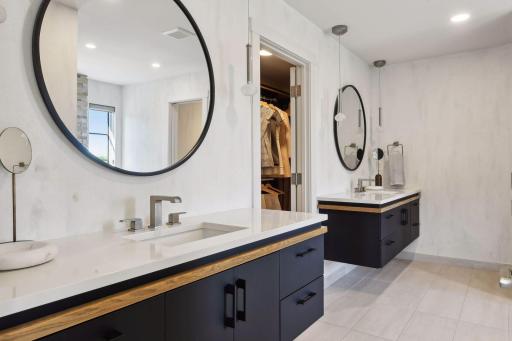 A continuation of the black cabinetry seen on the main floor - these beautiful black vanities are a striking touch