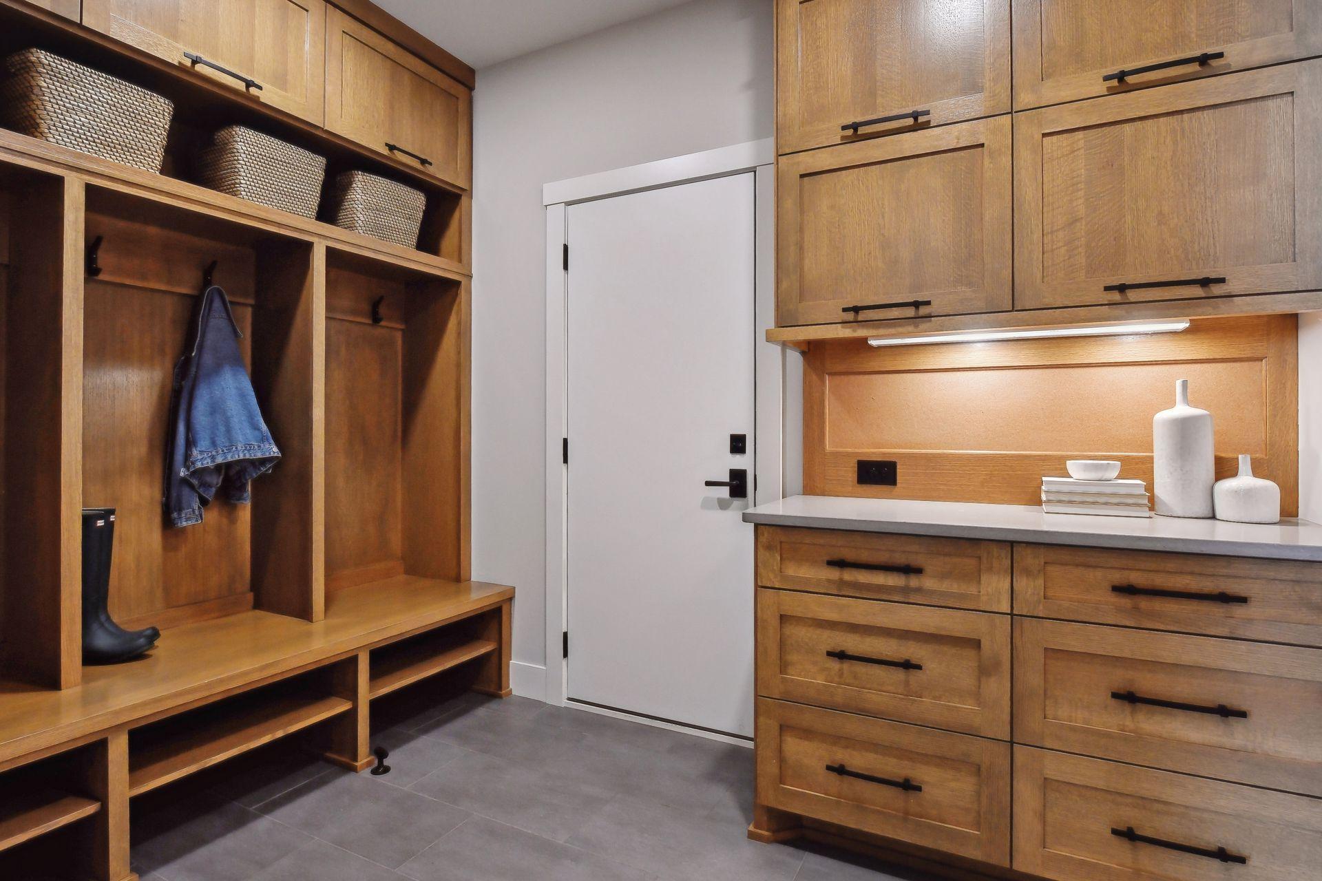 Mudroom features a locker bay, a drop station and a walk in closet.