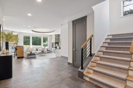 The basement stairs open up to the sun soaked, walkout basement.