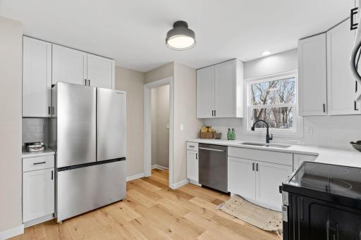 Kitchen features new cabinets, stainless steel appliances, and quartz countertops.