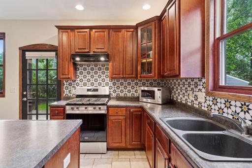 Stainless steel appliances including a 5 burner gas range.