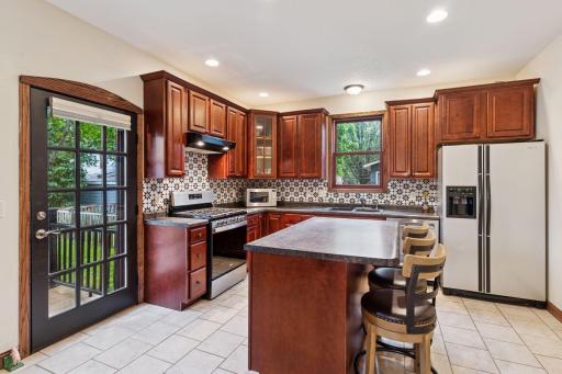 Functional and efficient center island with breakfast bar. You'll love the convenient walkout to the deck and backyard - makes it easy to move from the kitchen to the deck.
