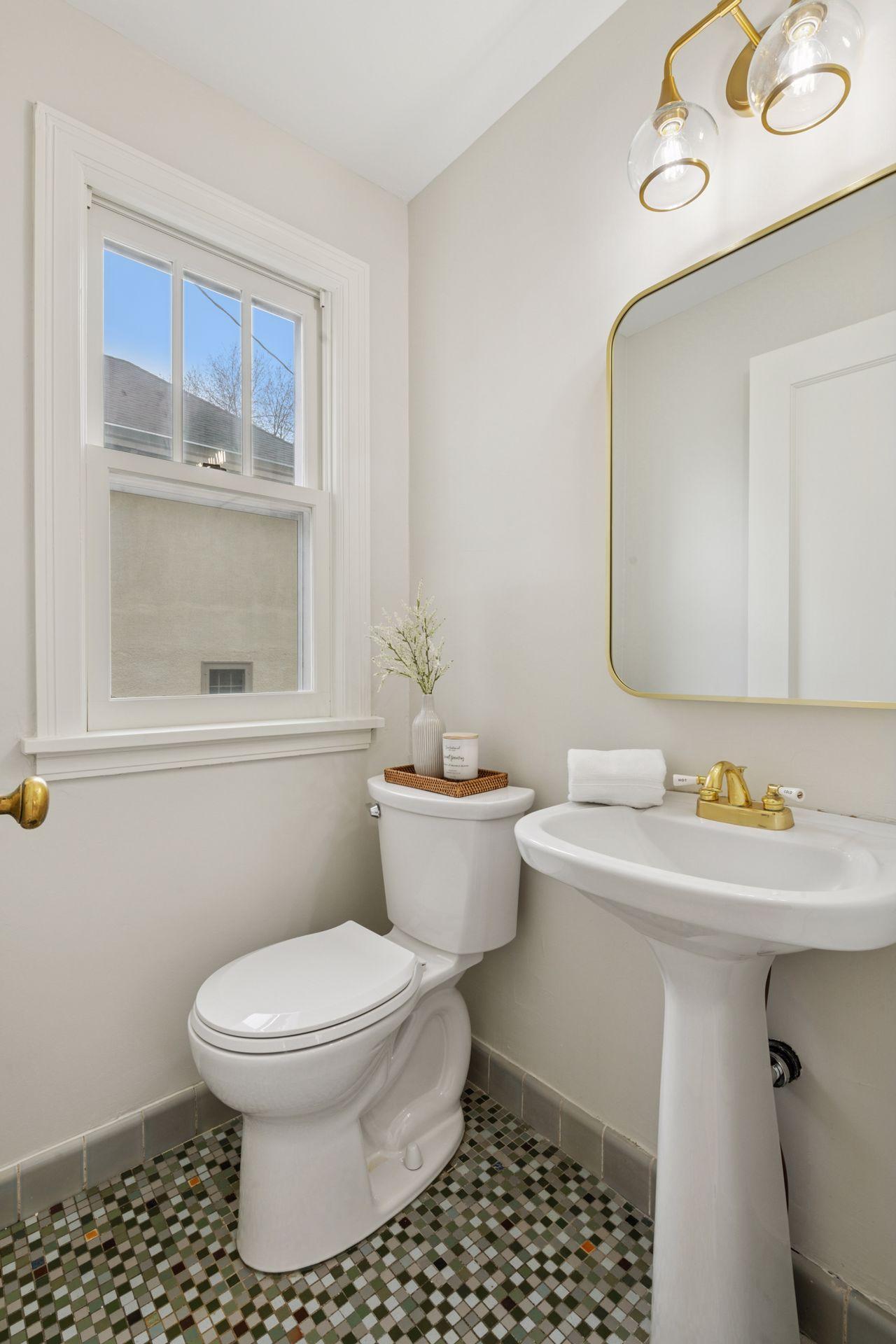 Main floor powder room adjacent to kitchen/rear entrance
