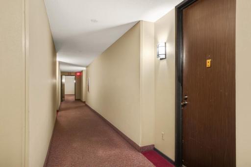 This shows the well-maintained hallway out side this condo unit.