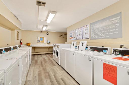 A common laundry space with a lot of machines to use.