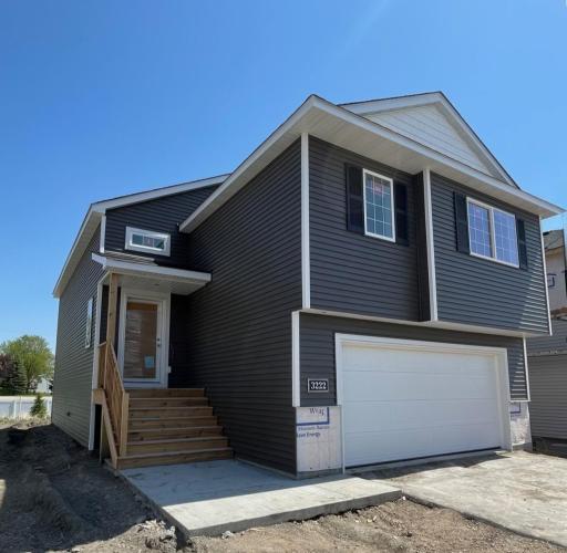 3222 Kady Ave NE- Stone accents will be installed soon. Home features a finished walkout lower level. Sod, Irrigation System, and Landscaping included.