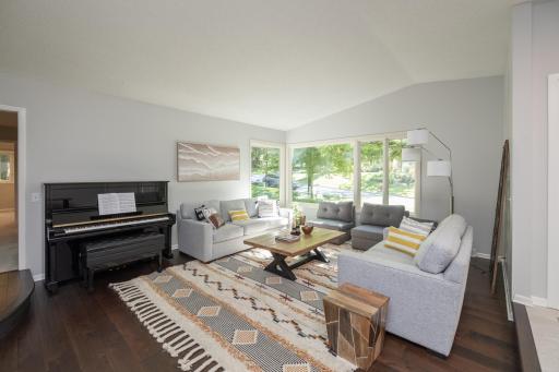 Main floor living room with neutral colors and contrasting floor