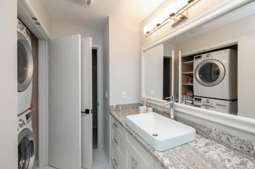 Main floor bath with granite counters, stackable washer & dryer, new tile, tub and fixtures