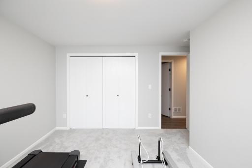 Lower level bedroom currently being used as a workout room