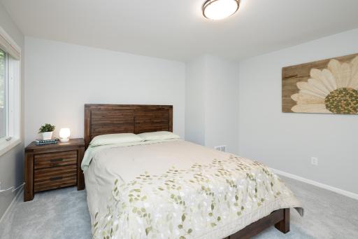 This lower level bedroom is one of six in the home